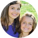 Two girls smiling at the dentist