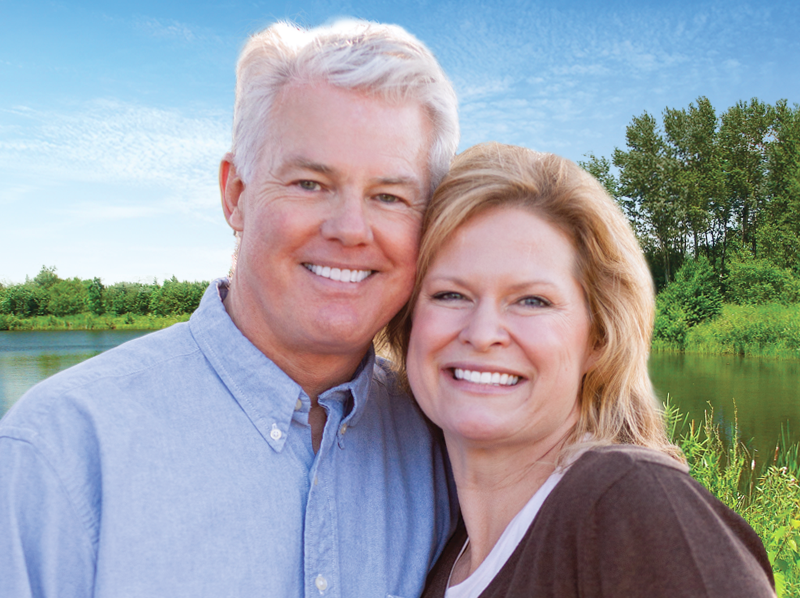 Couple smiling with dental implants